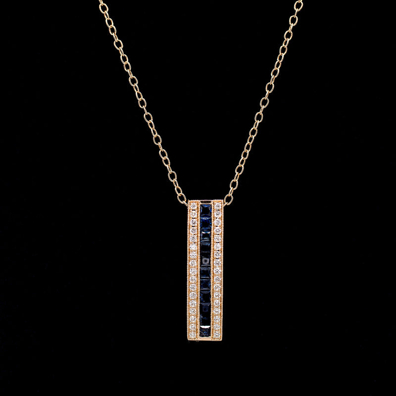 Vertical bar pendant in 14K yellow gold with a channel-set row of blue sapphires framed by two rows of diamonds — Gent Jay Jewelry Blue Line Collection