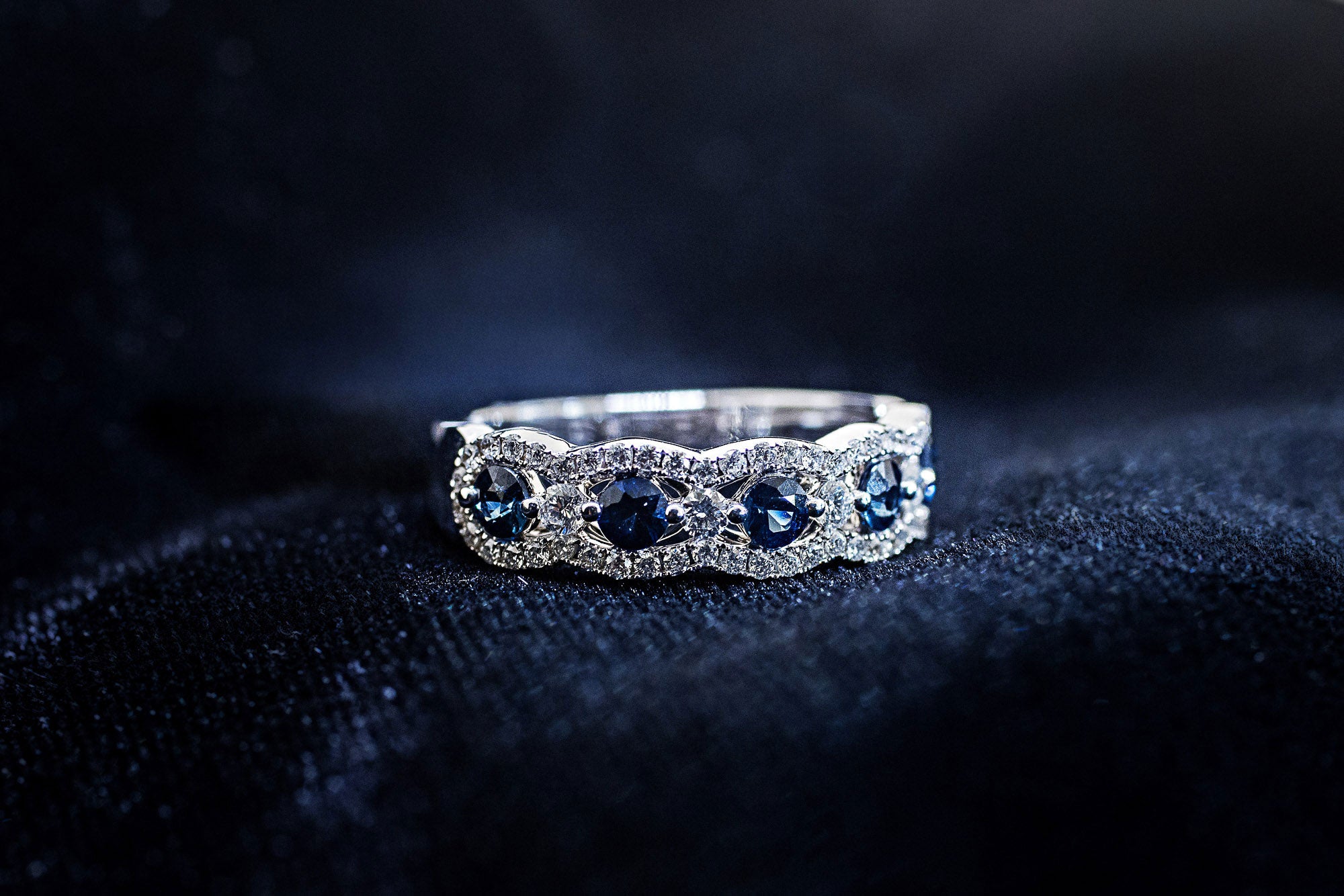 Alternating round blue sapphire and diamond band with scalloped diamond border in 14K white gold