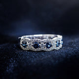 Alternating round blue sapphire and diamond band with scalloped diamond border in 14K white gold