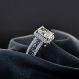 Side view of sapphire channel band on diamond halo engagement ring