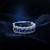 Oval blue sapphire band with diamond halos in 14K white gold