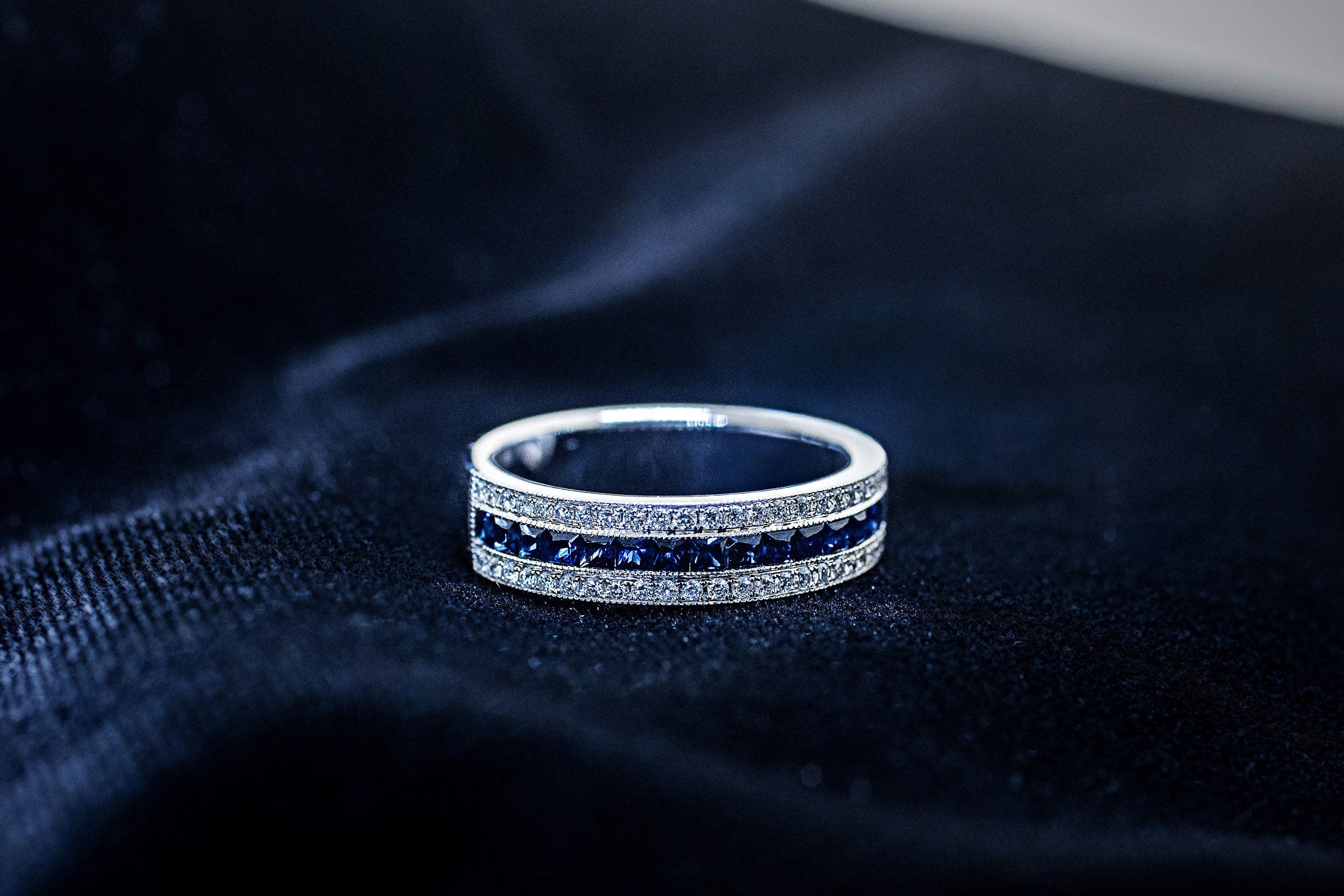 Blue sapphire channel band with diamond rows in 14K white gold